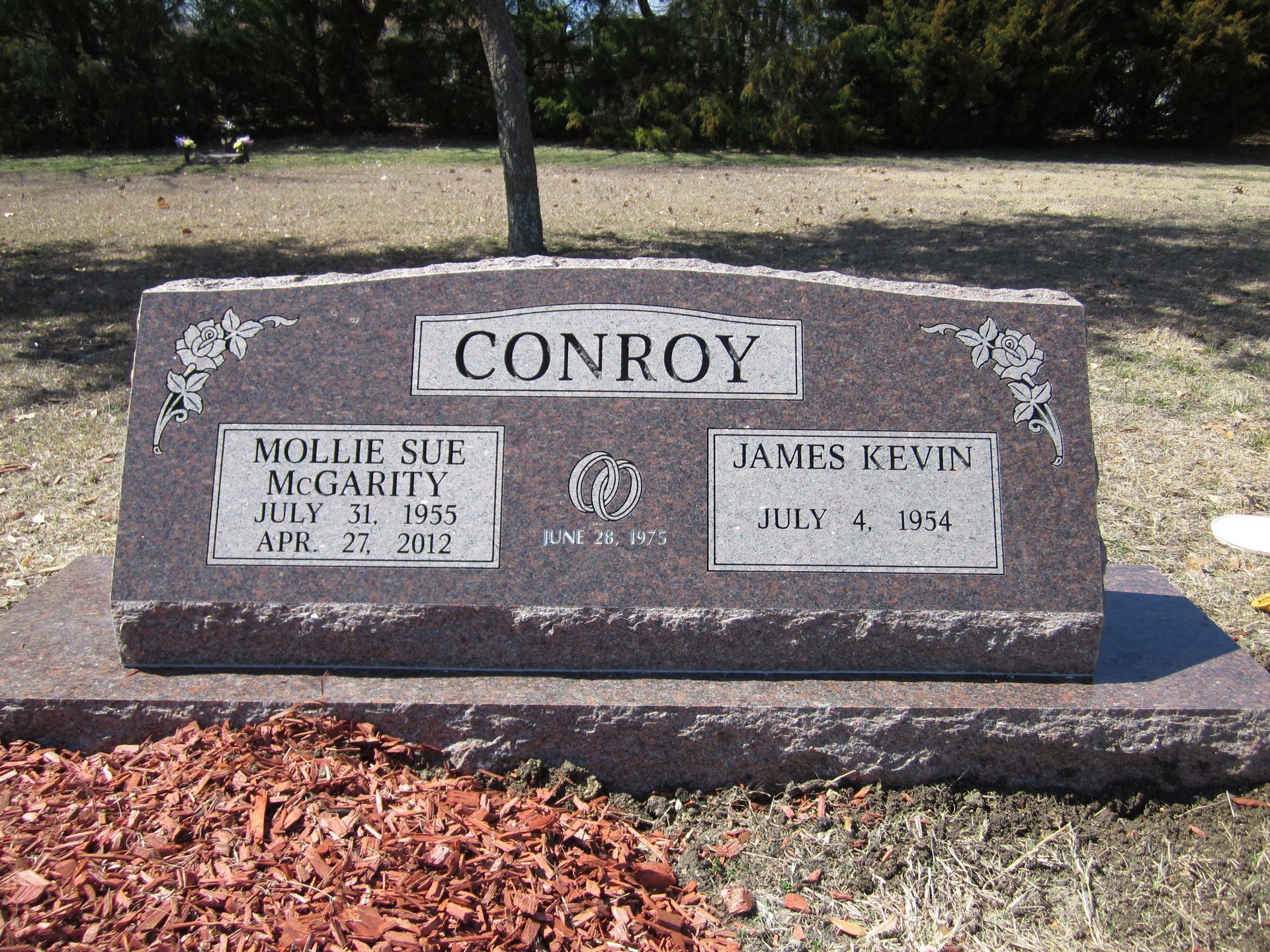 Headstone for Conroy family; features names Mollie Sud Mcgarity and James Kevin, with birth and death dates, in a cemetery.