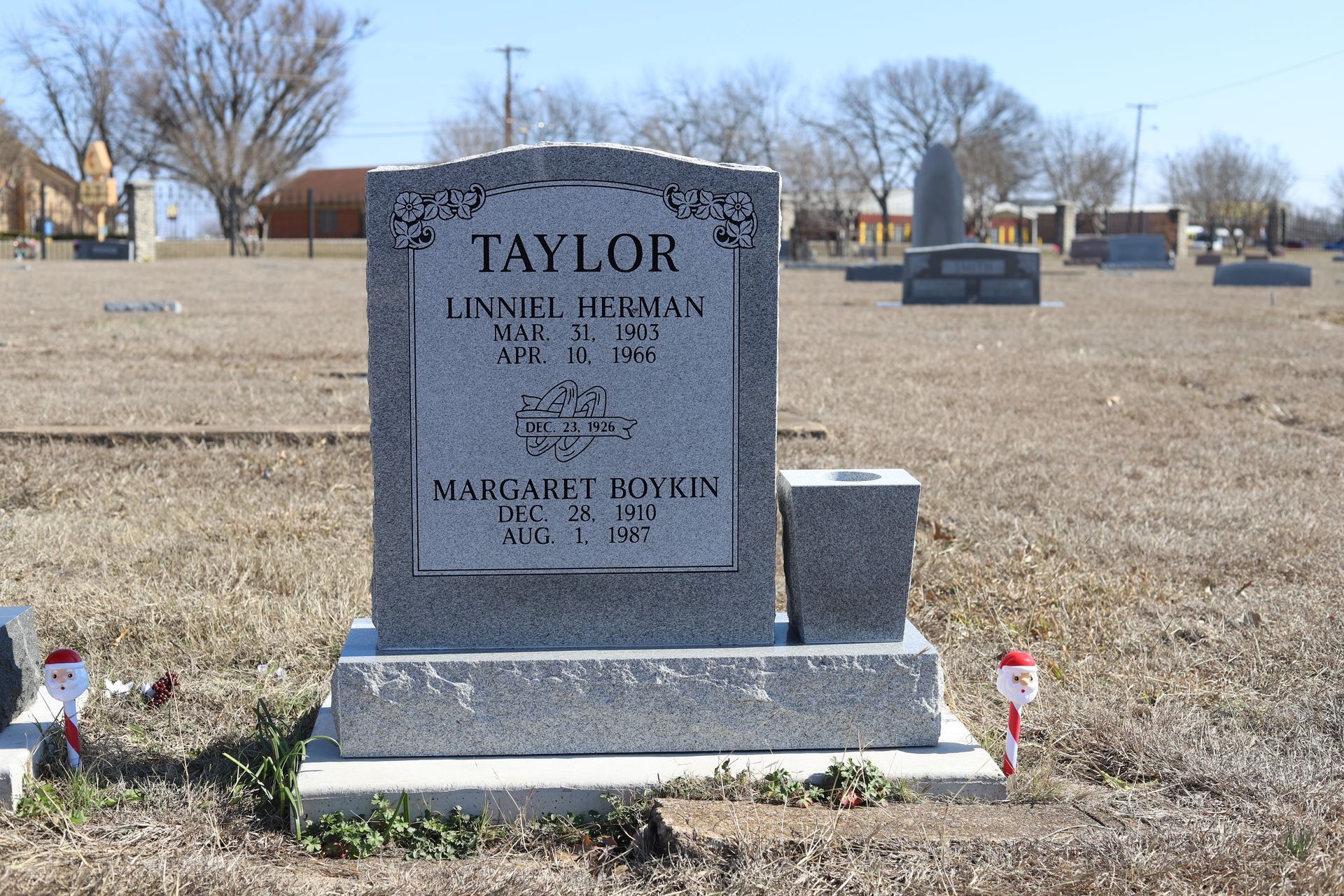 Gray tombstone with the name Taylor in a cemetery.