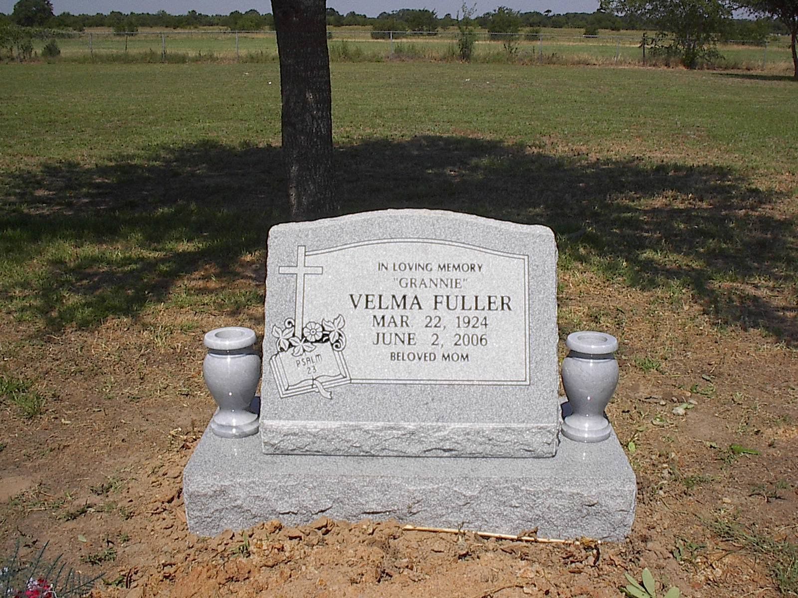 Headstone of Velma Fuller, dates Mar 22, 1928 - June 2, 2016, in a grassy field. Two vases flank the stone.