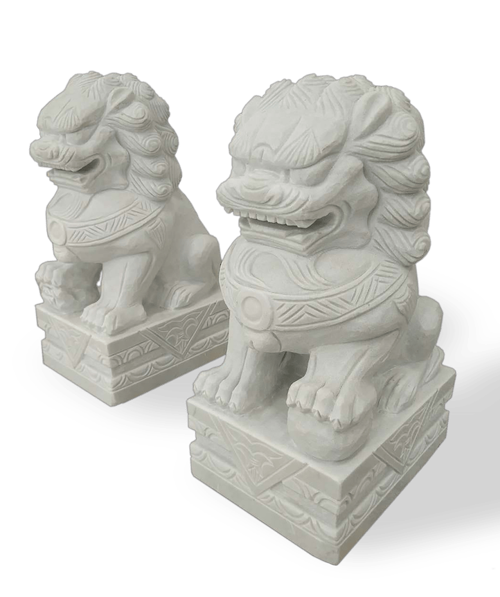 Two white stone guardian lions on rectangular bases.