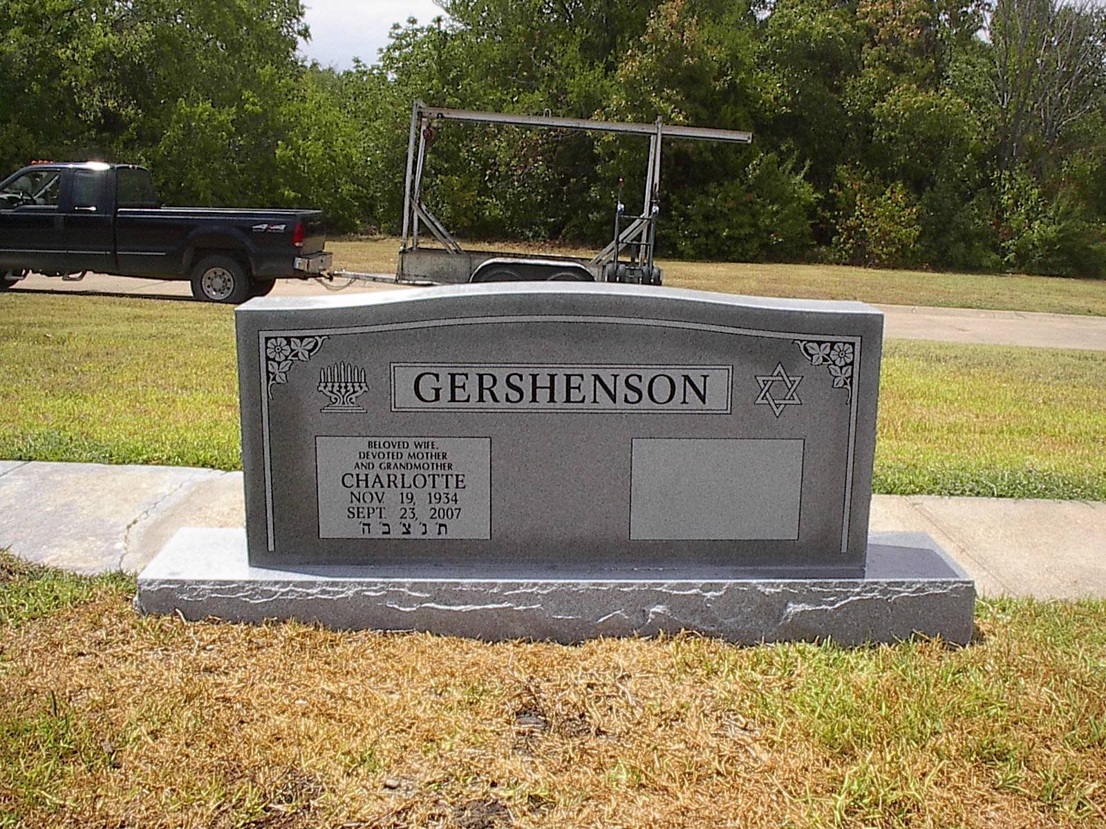 Gravestone for the Gershenson family, with one inscription, in a cemetery on a sunny day.
