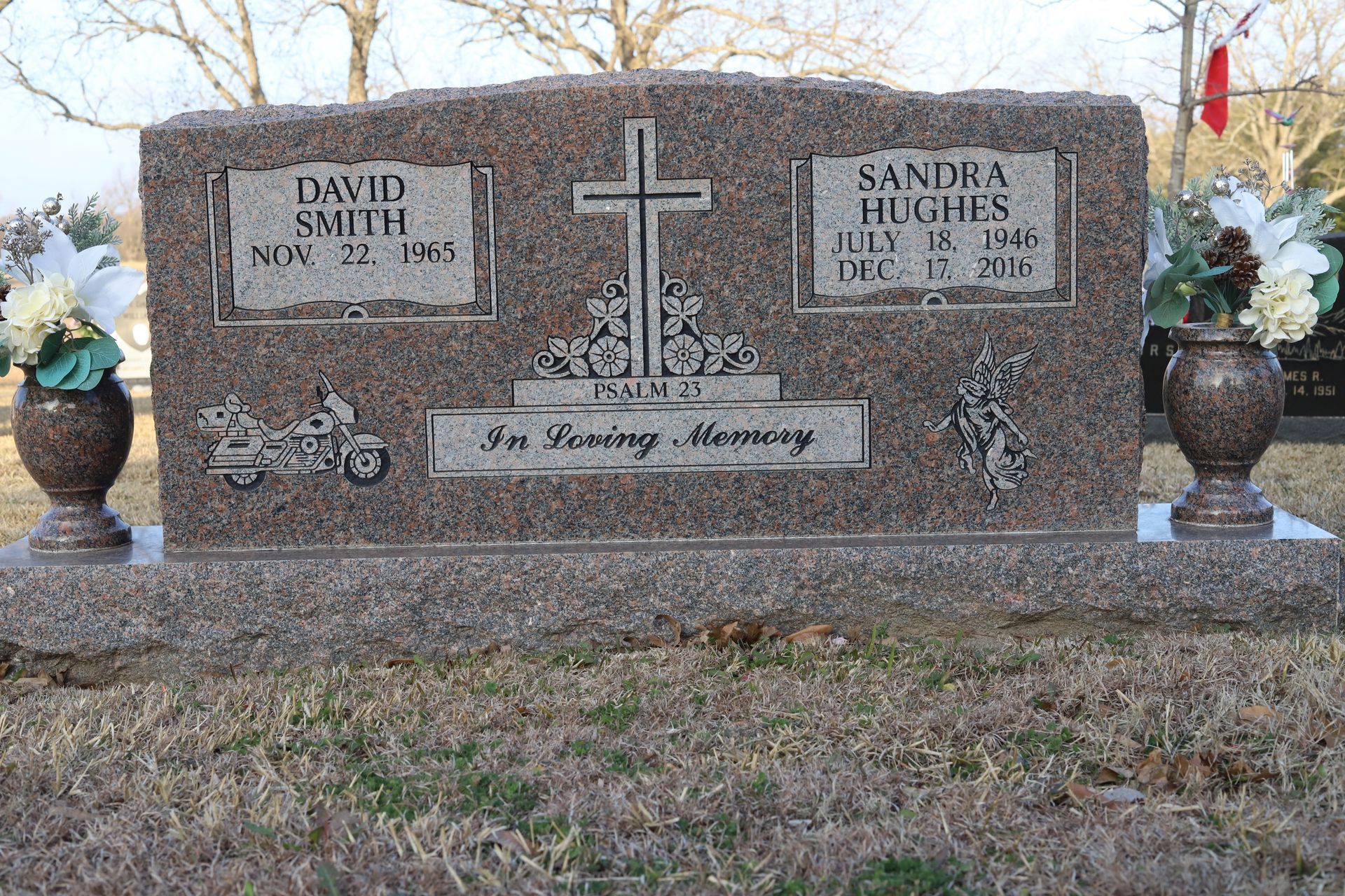 Grave marker with names David Smith and Sandra Hughes, a cross, and