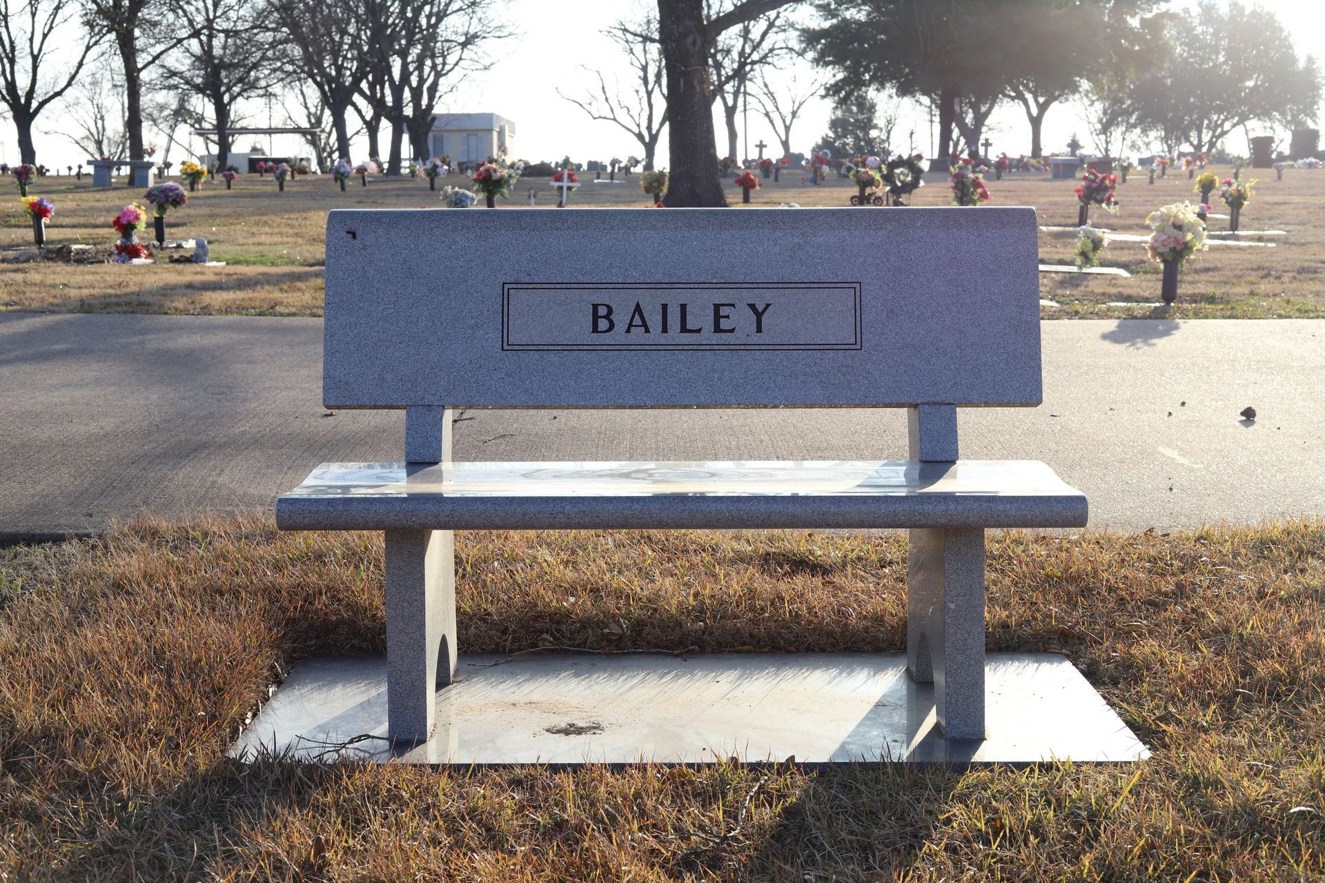Granite bench in a cemetery with the name 