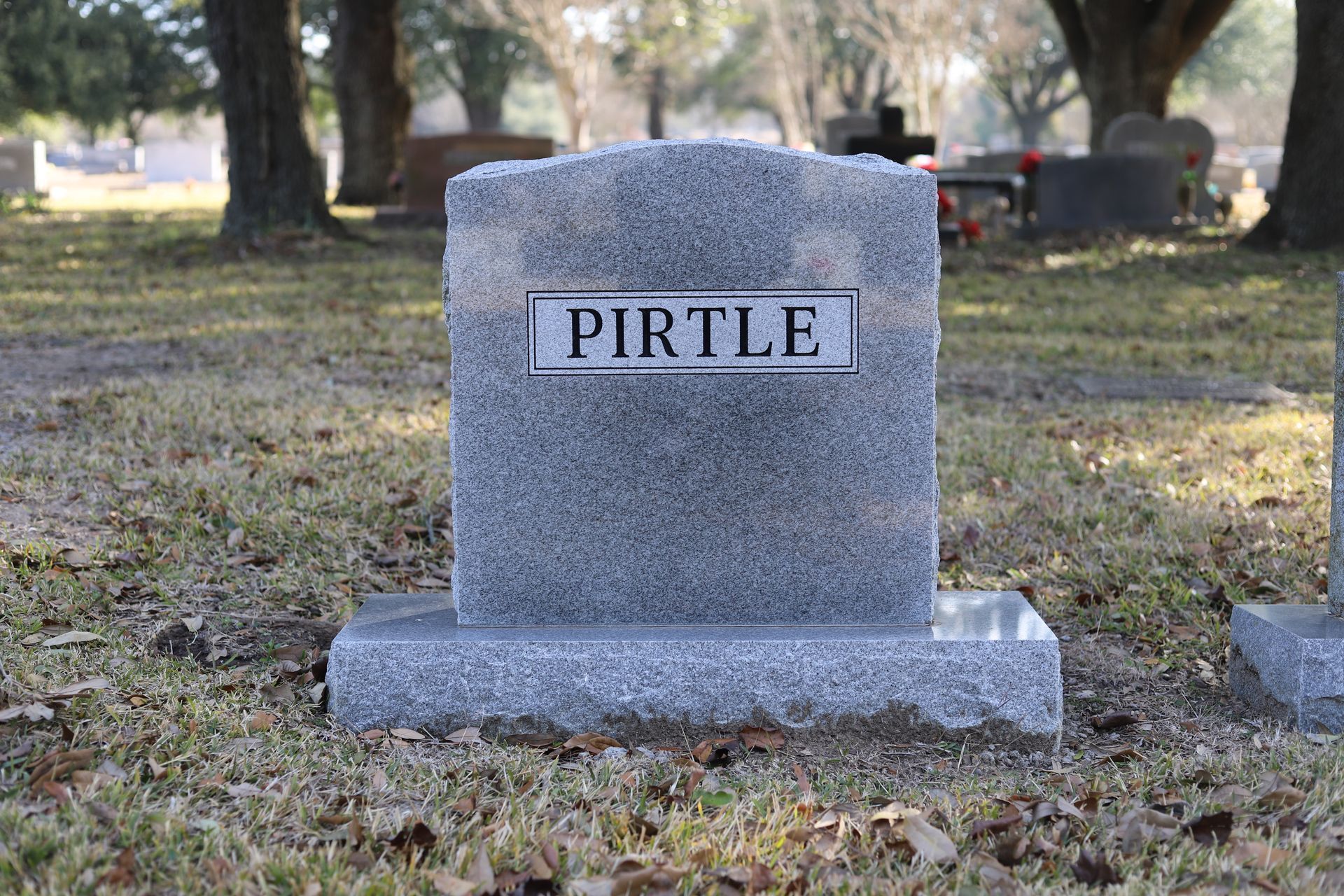 Gray granite headstone with the name