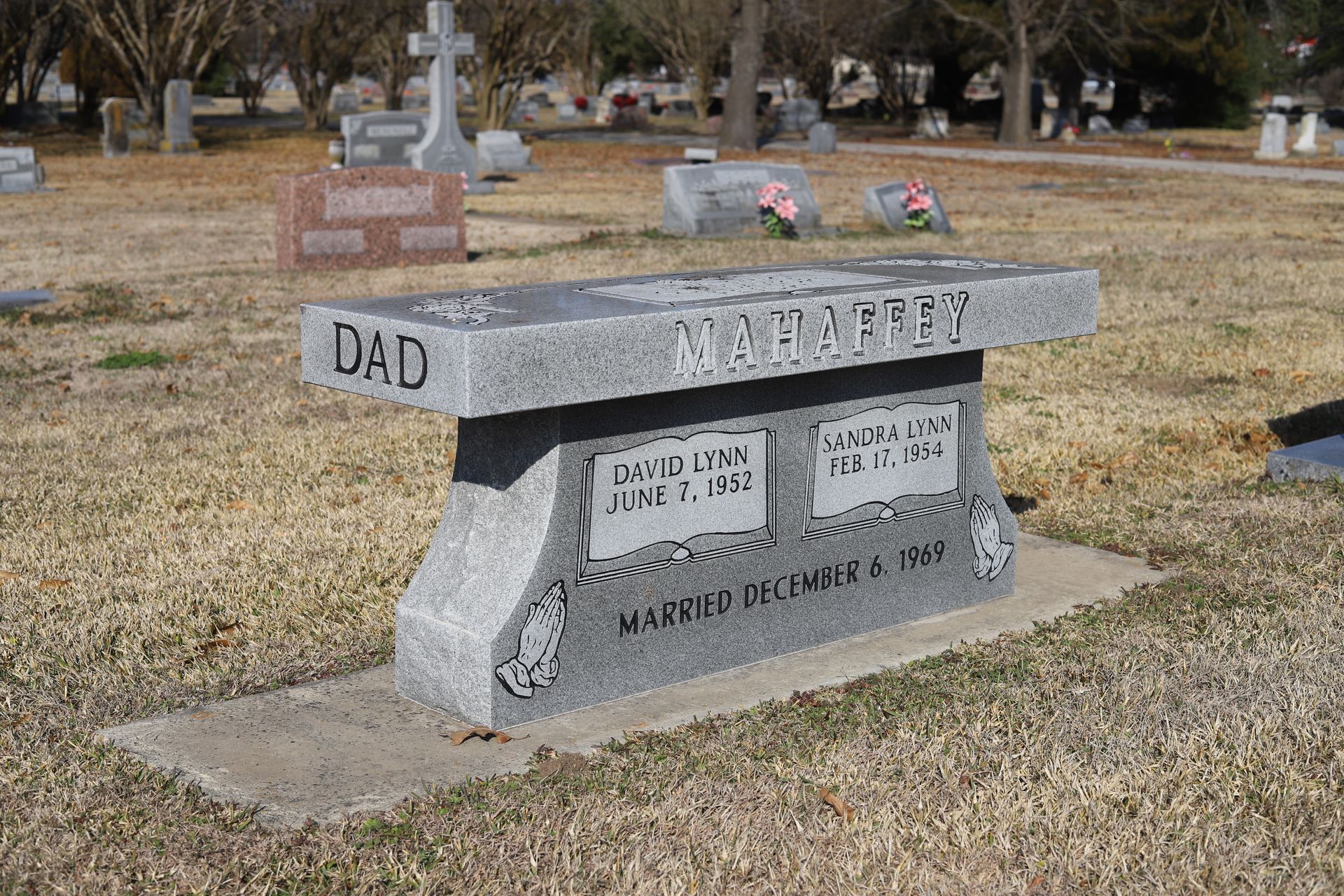 Granite bench gravestone in a cemetery with 