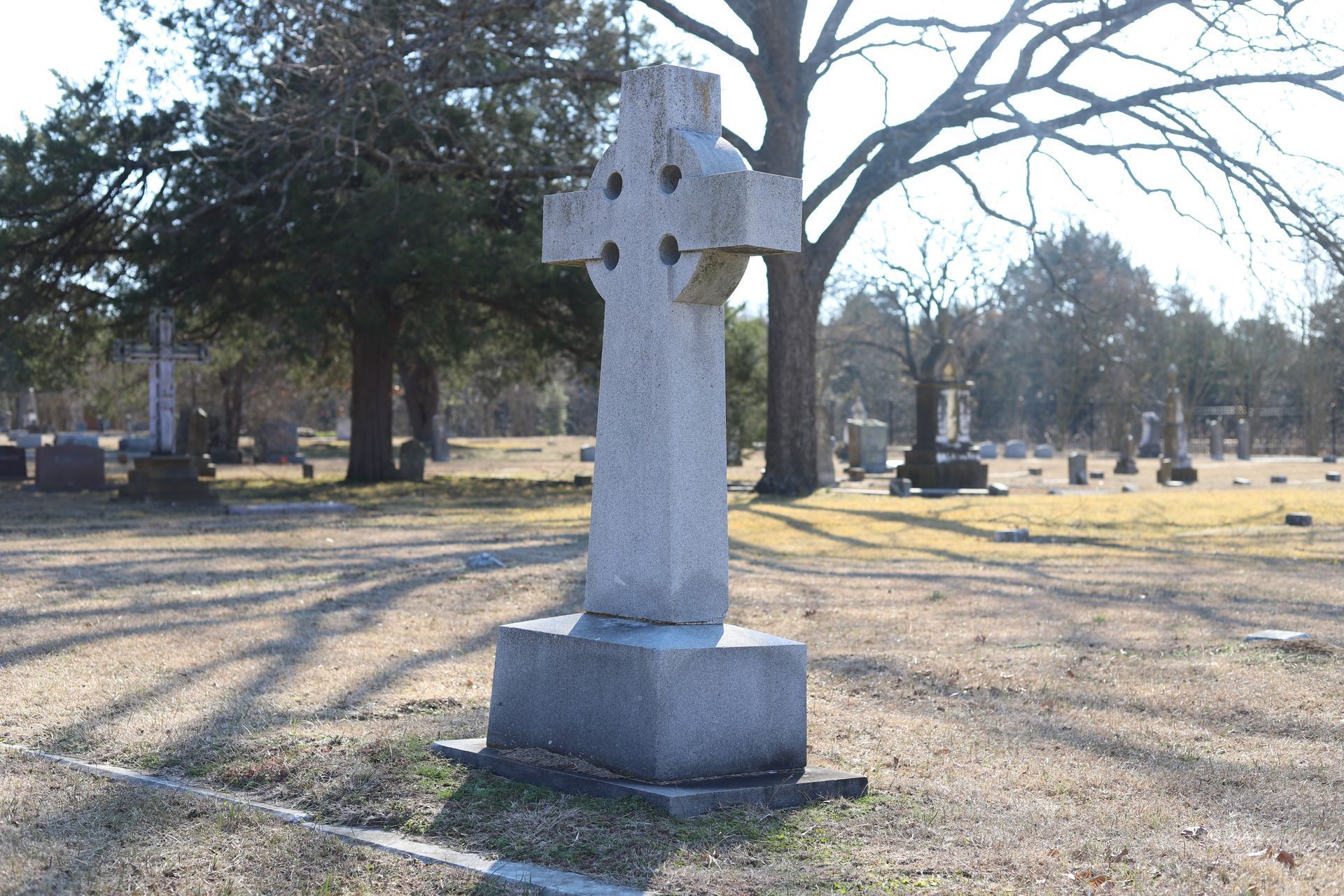 Celtic cross headstone in a cemetery.