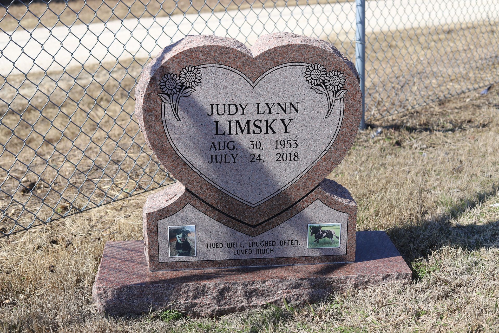 Heart-shaped tombstone for Judy Lynn Limsky, with dates Aug 30, 1975 - July 24, 2013, with photos, in a grassy cemetery.