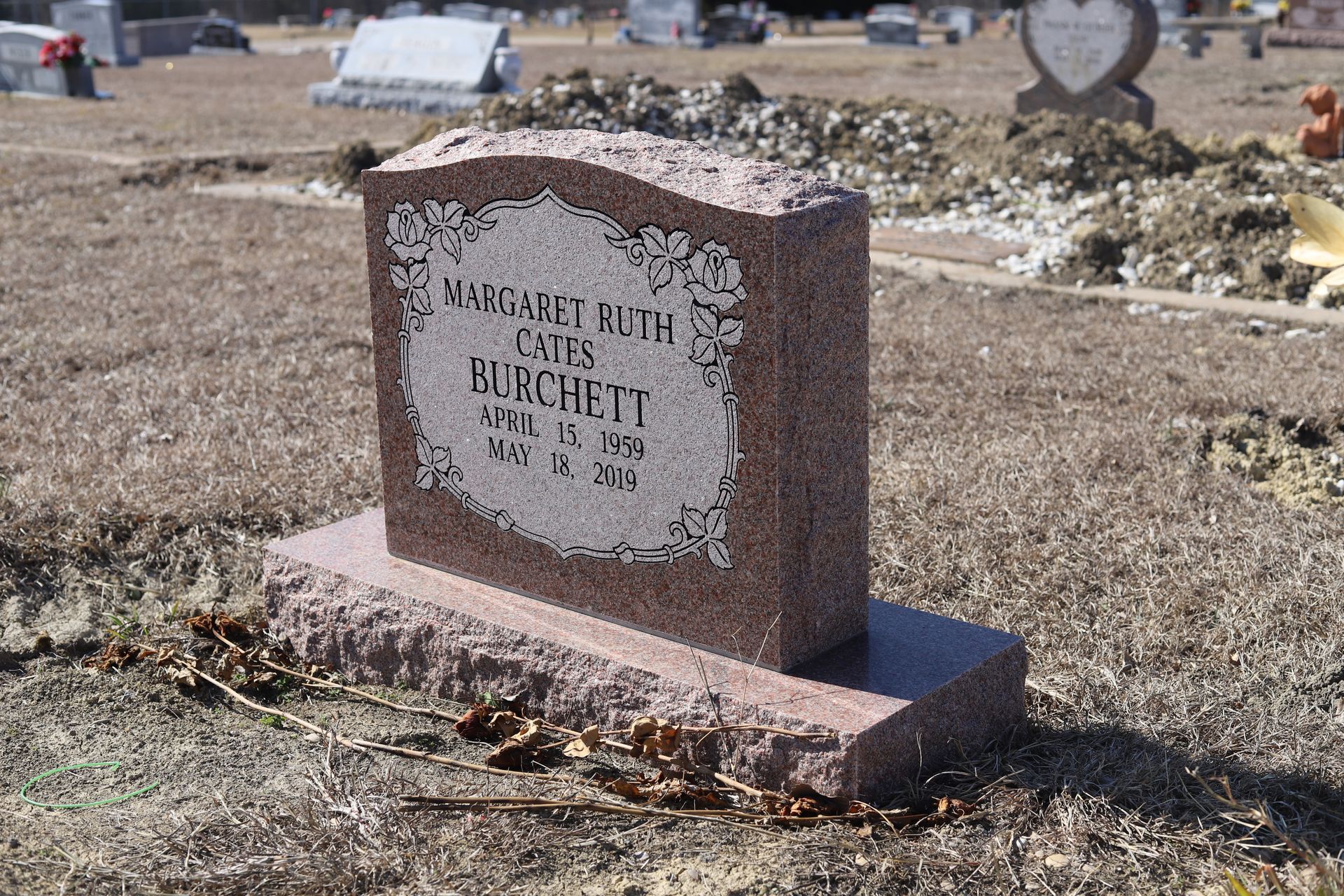 Red granite headstone in a cemetery; inscription for Margaret Ruth Gunchrett, died May 15, 1984.