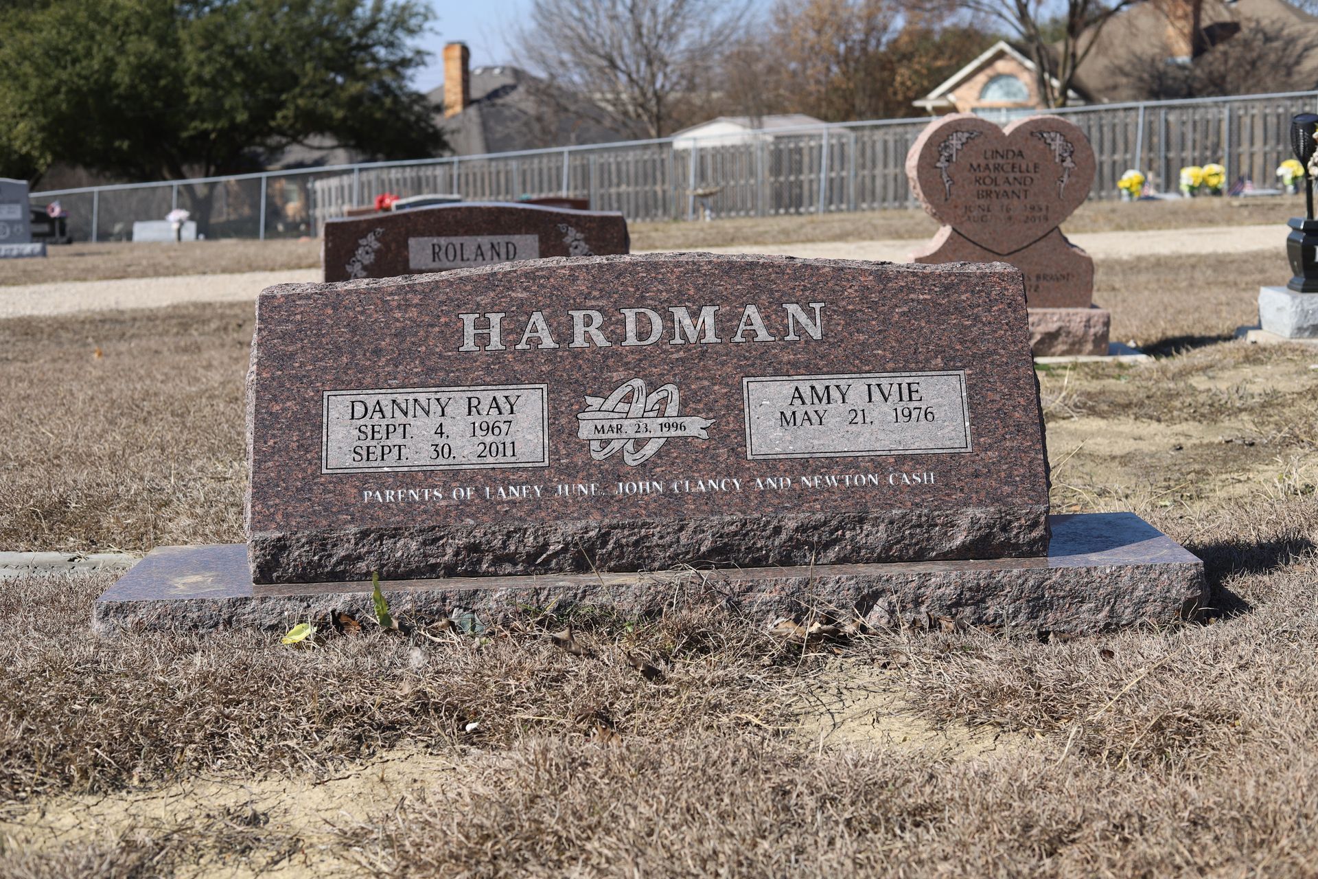 Red granite headstone at a cemetery with