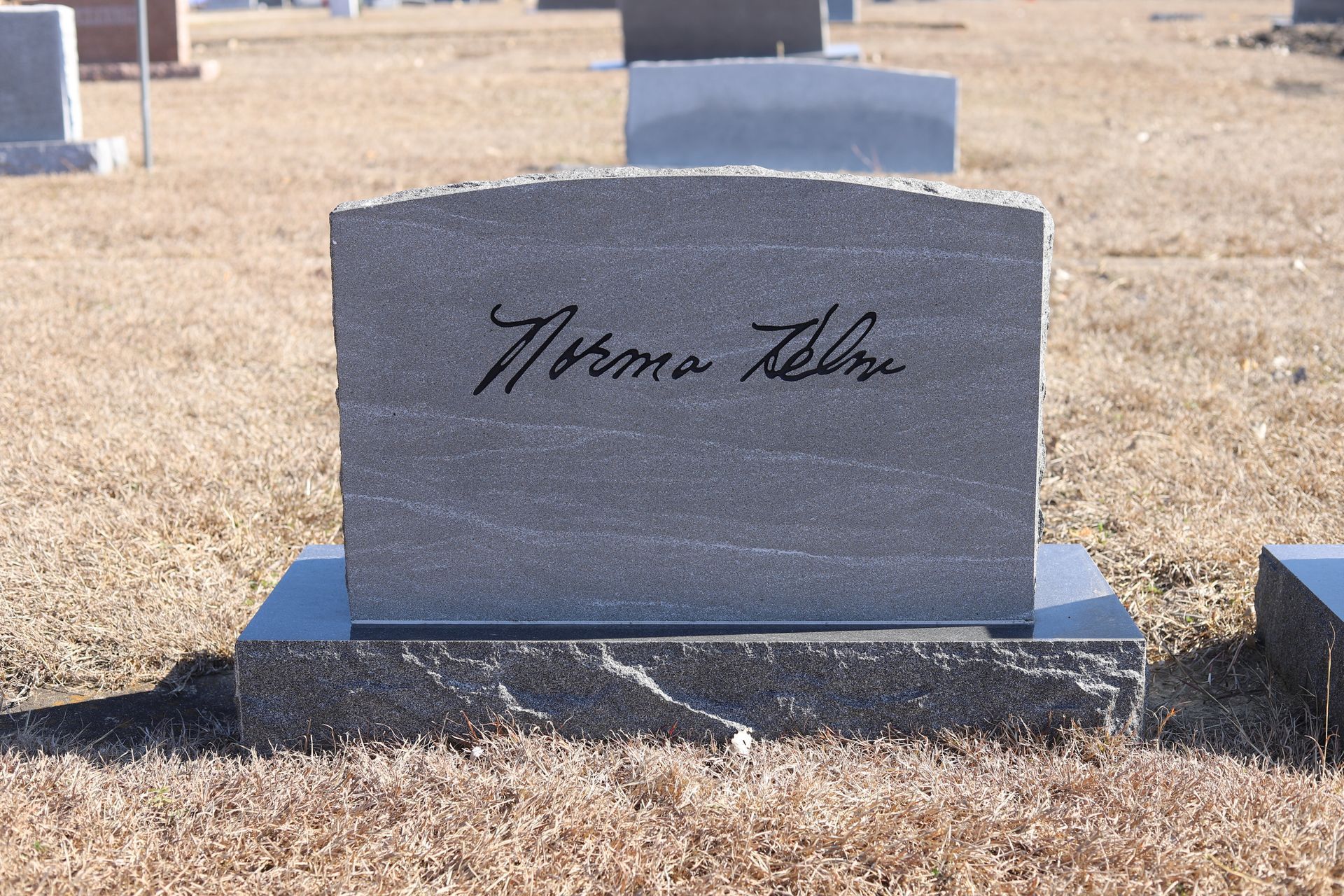 Grey headstone with the name