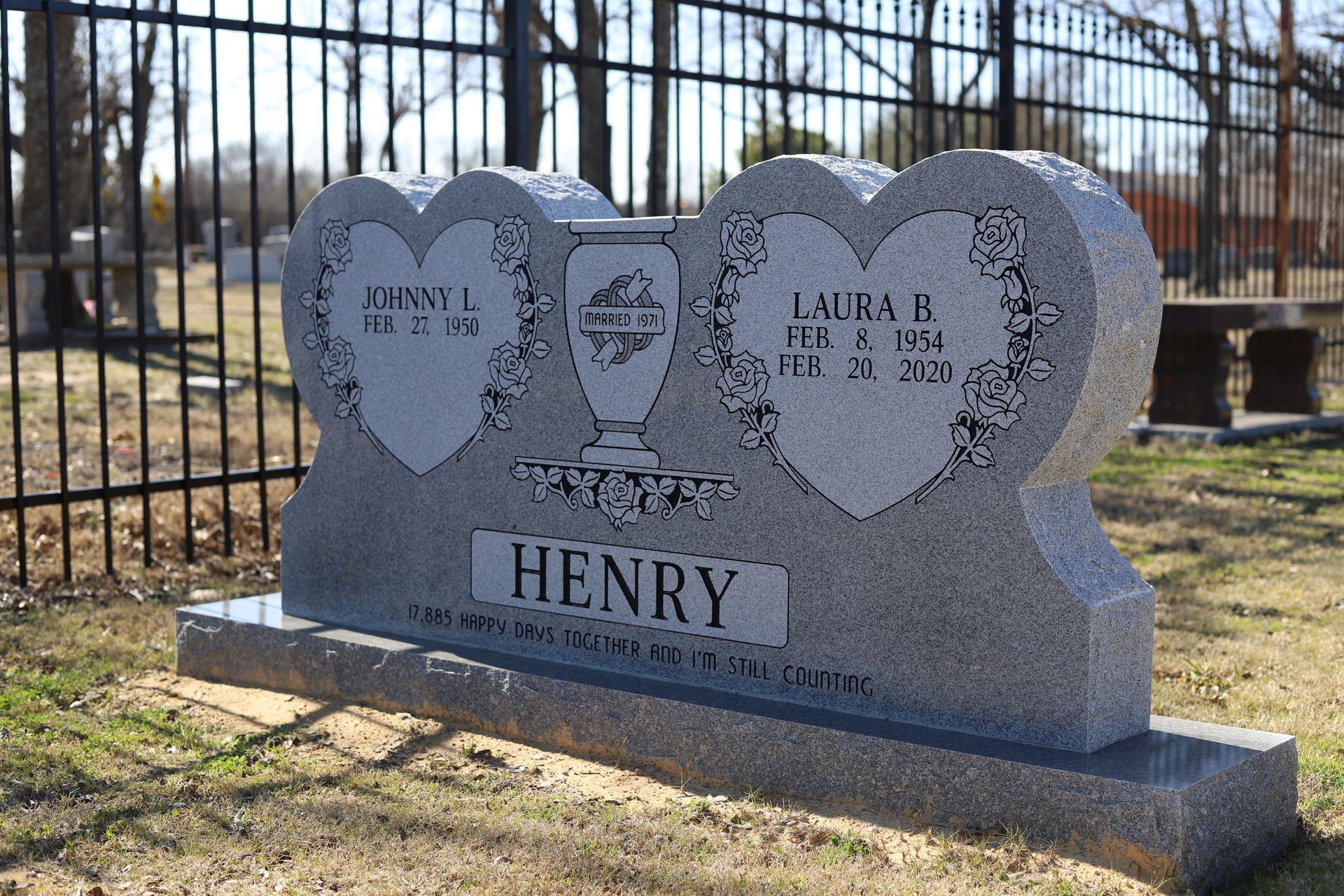 A double-heart-shaped headstone with names 