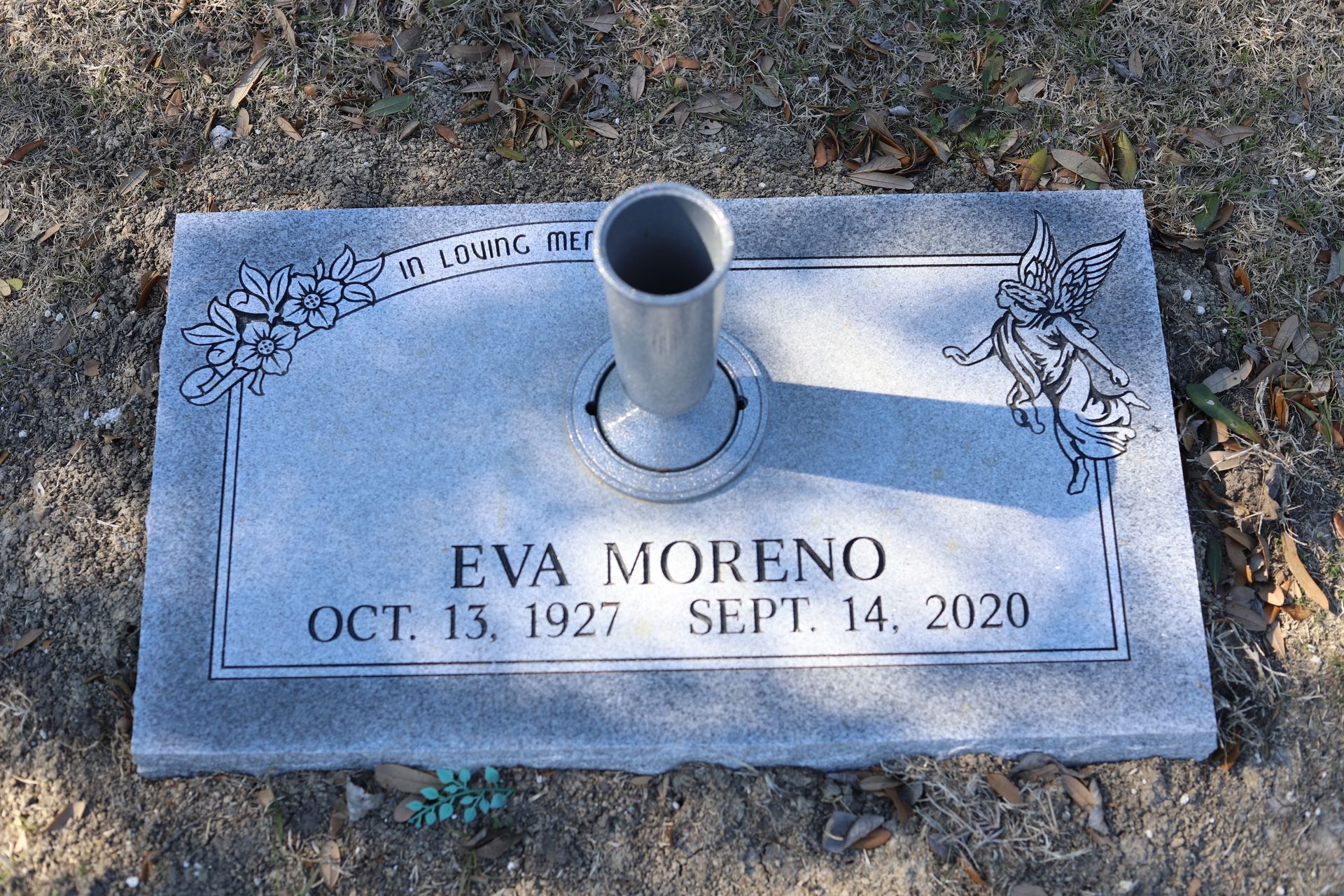 Gray headstone with the name EVA MORENO and dates Oct. 13, 1927 - Sept. 14, 2020. Floral and angel design.