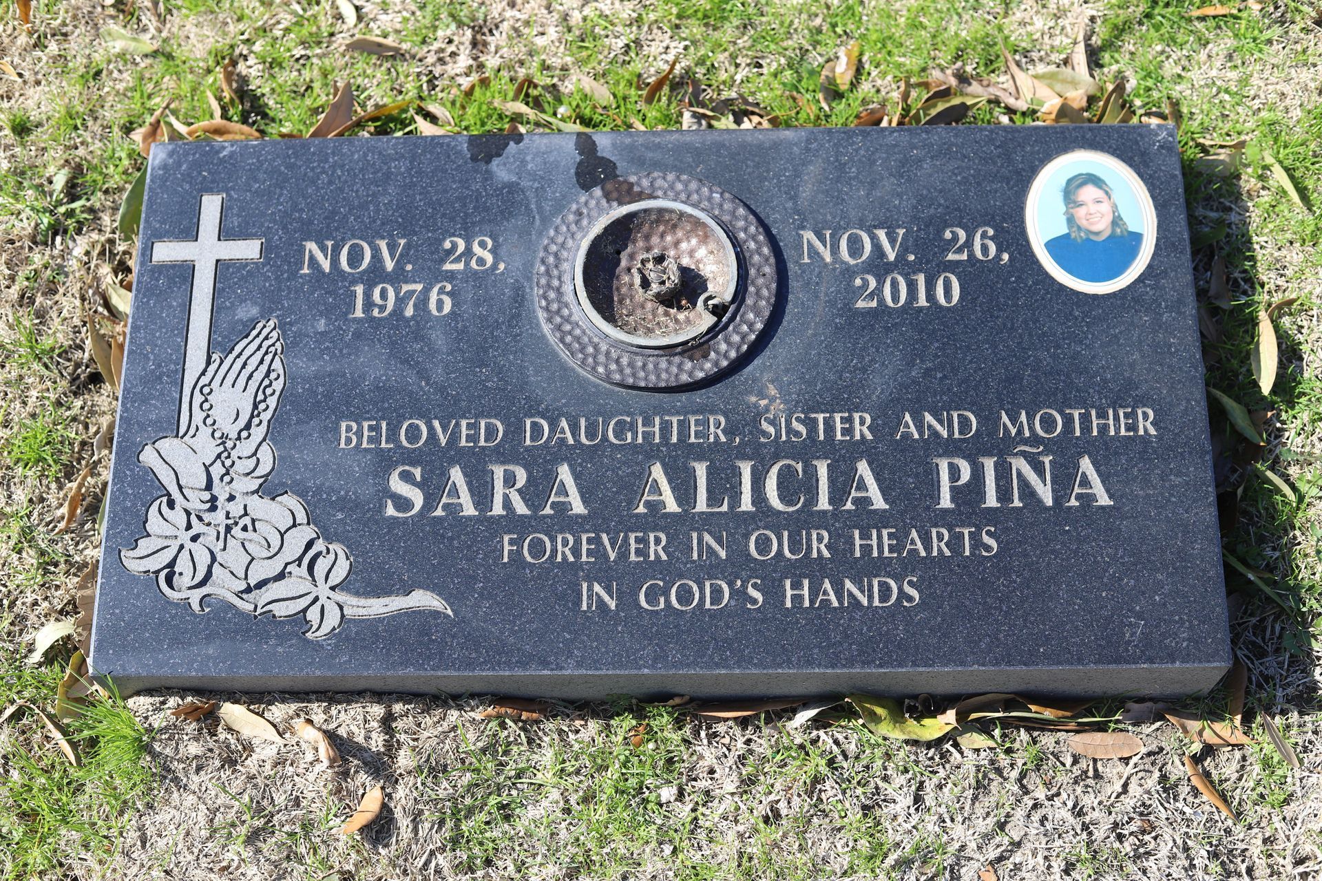 Black headstone engraved with 
