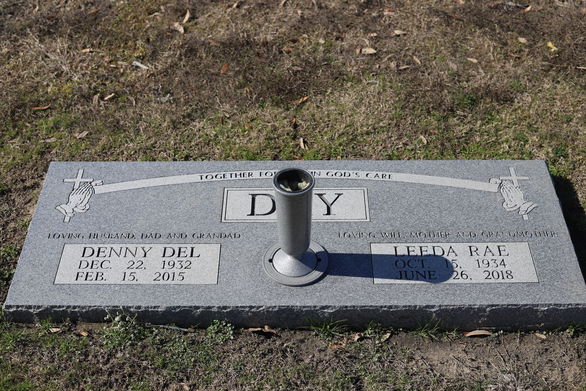Headstone for Denny Del and Leda Day, with dates of birth and death. Silver vase stands centered.