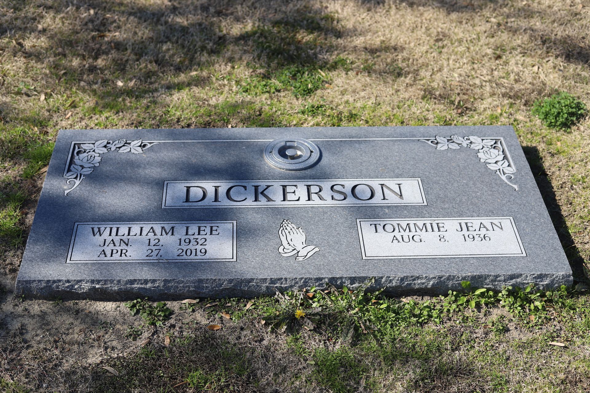 Gray headstone in grass; 