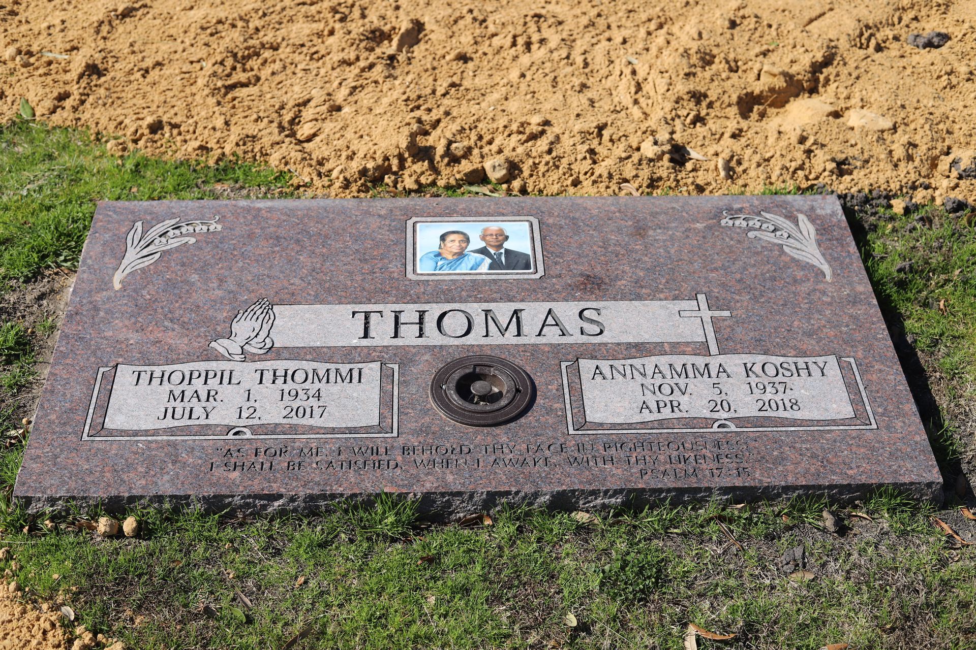 Headstone in a grassy area, engraved 