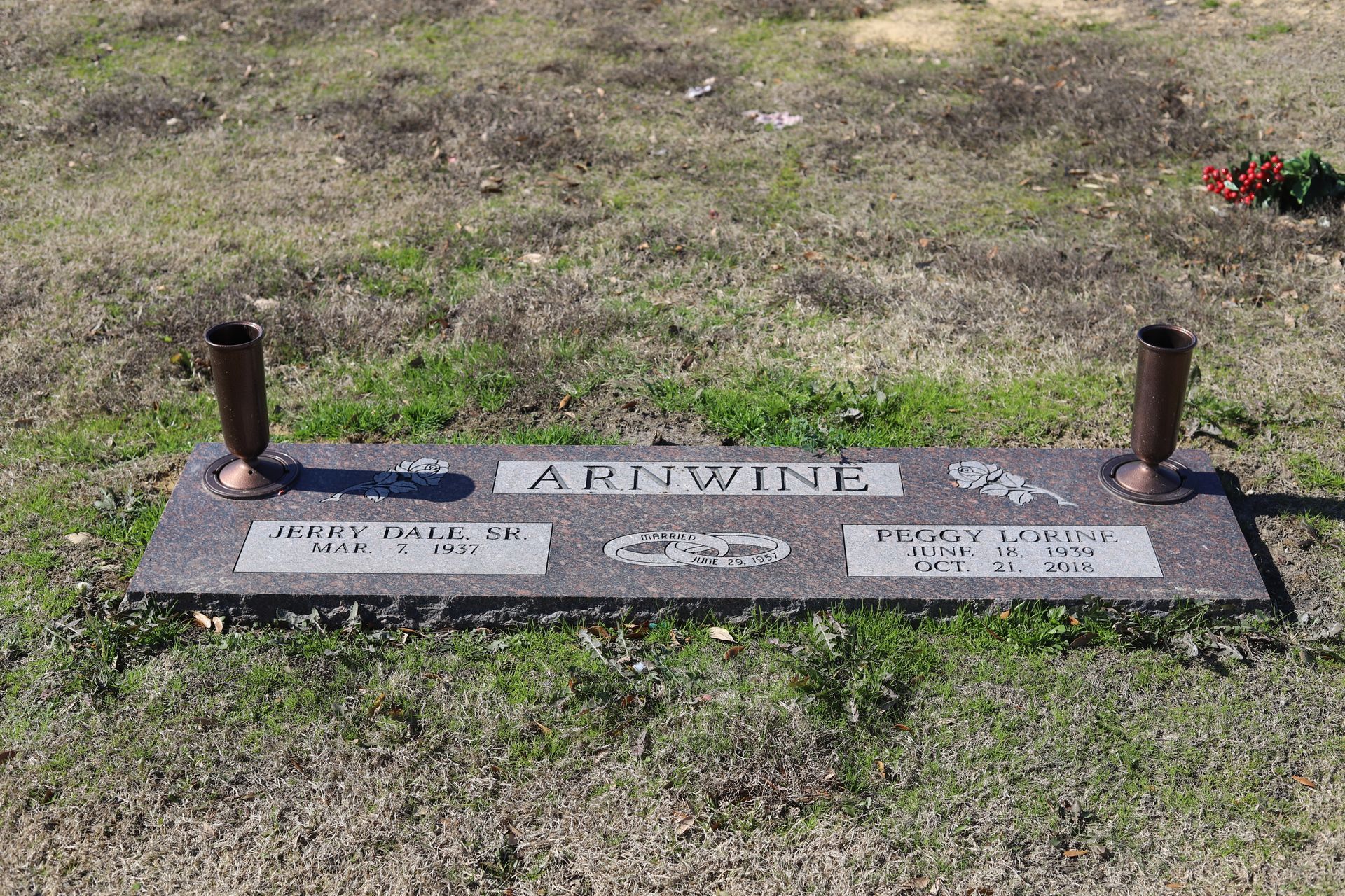 Grave marker in a grassy field with the name 