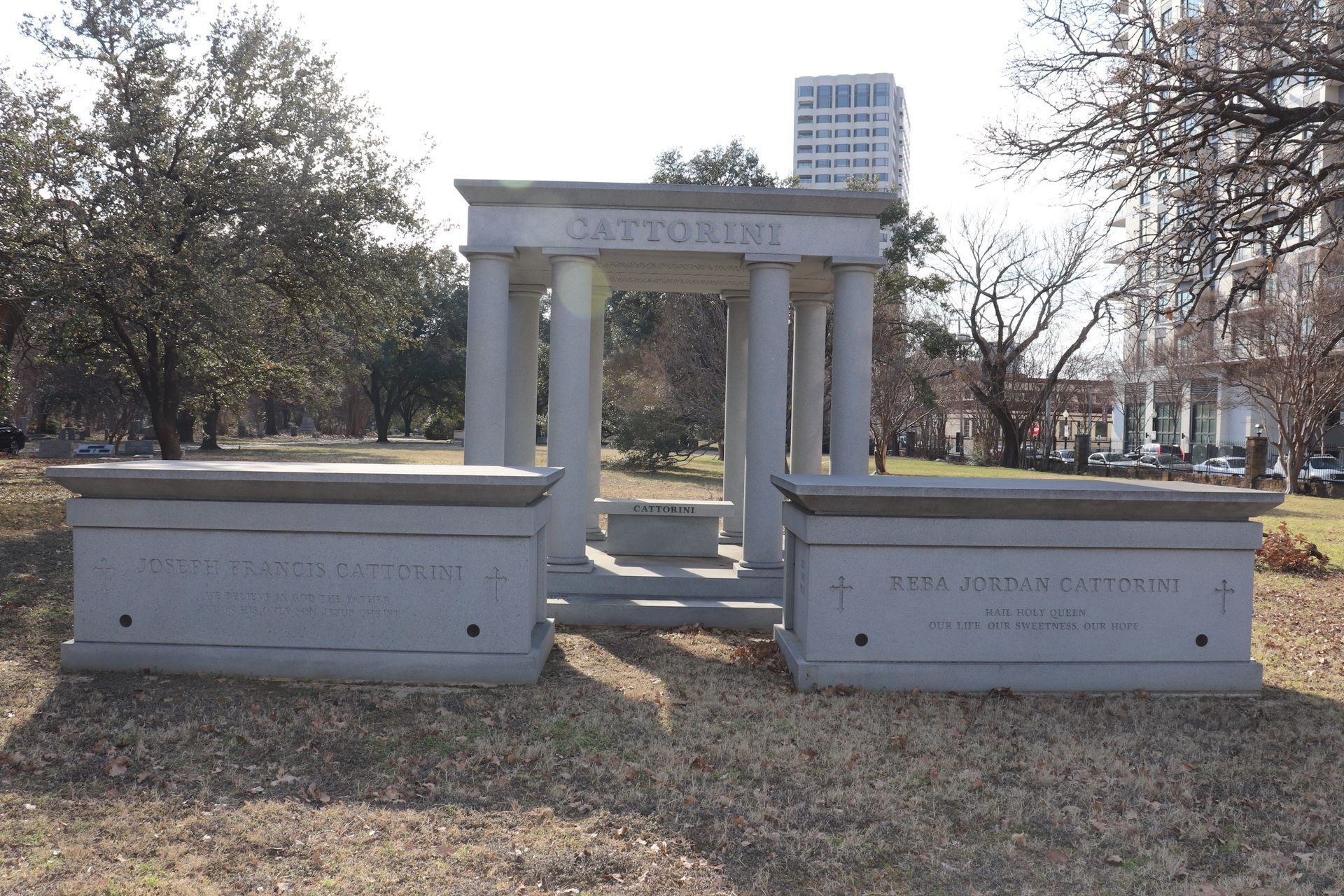 Stone mausoleum with columns in a grassy park setting, “Gazzorini” inscribed on top.