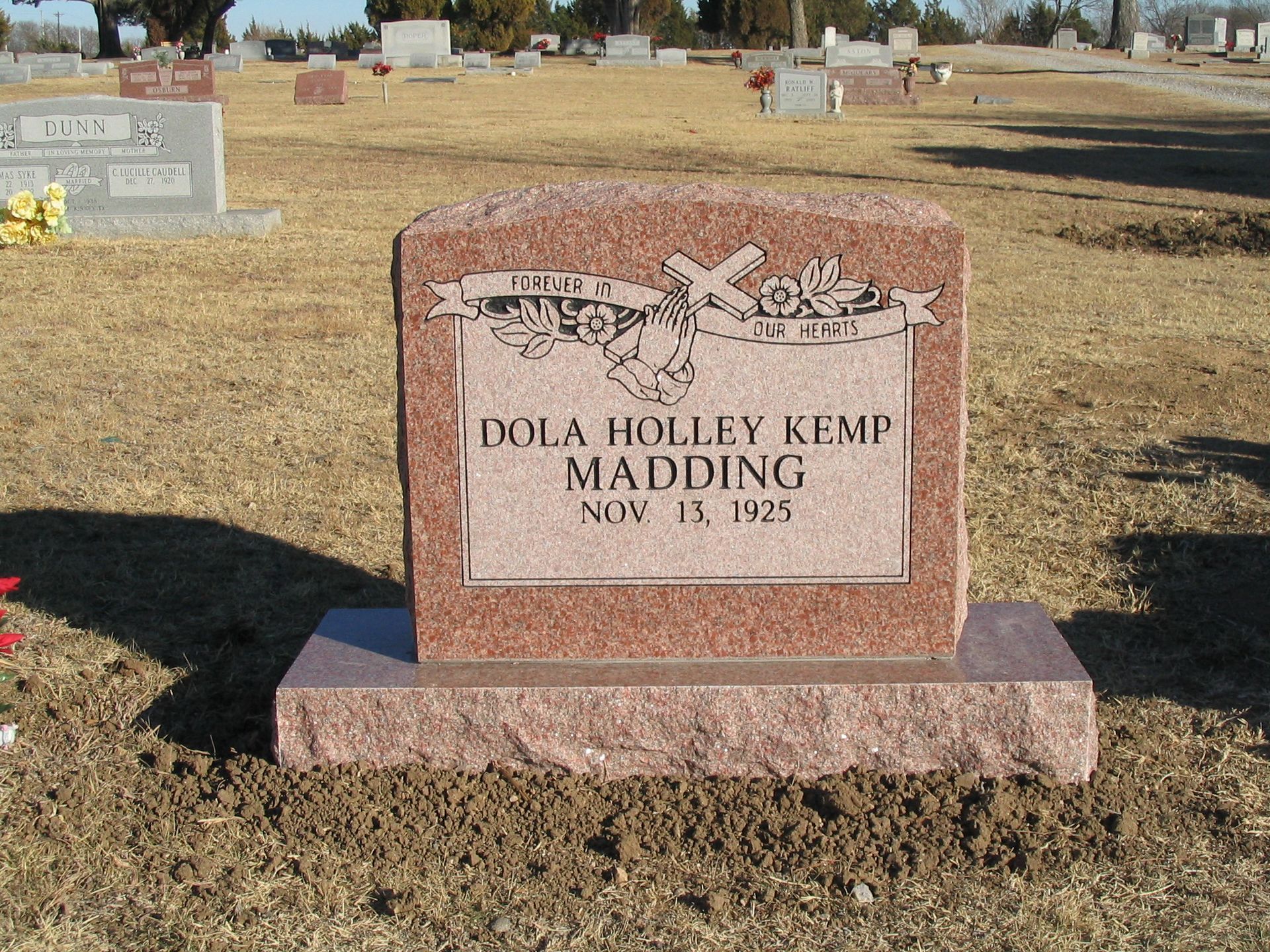 Red granite headstone with name