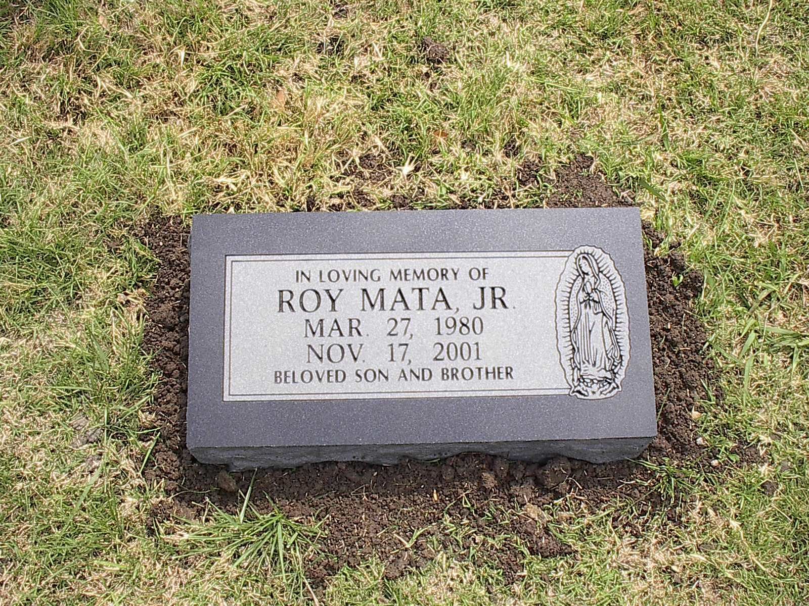 Headstone for Roy Mata Jr. with birth/death dates, a Marian image, and the words 
