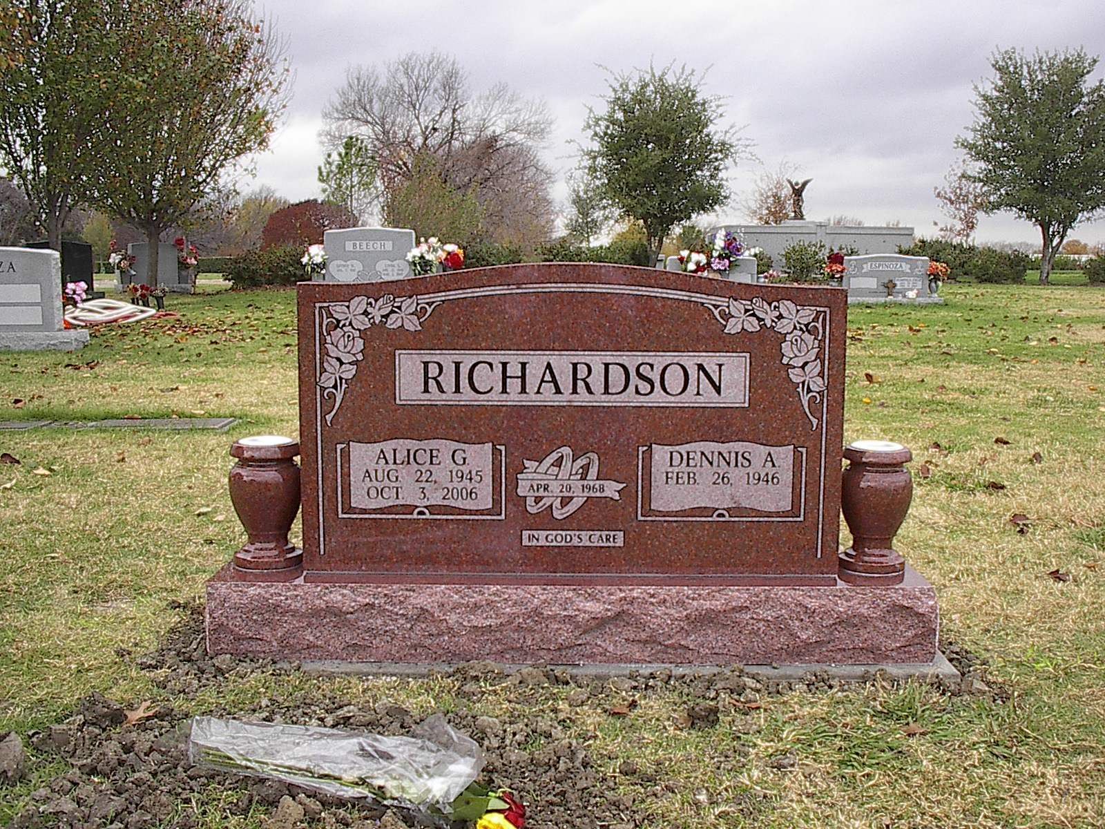 Red granite headstone in a cemetery with the name Richardson.