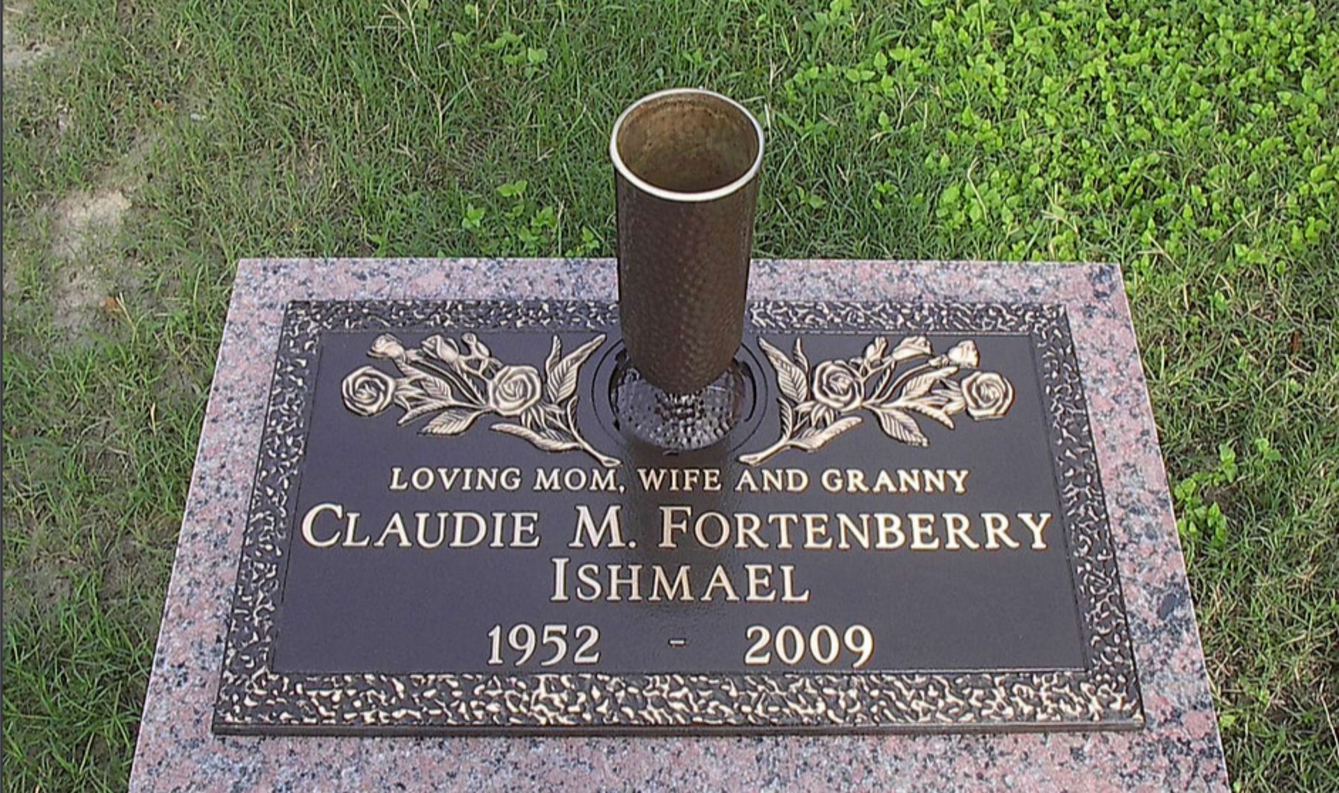Bronze headstone with a flower vase, engraved with 