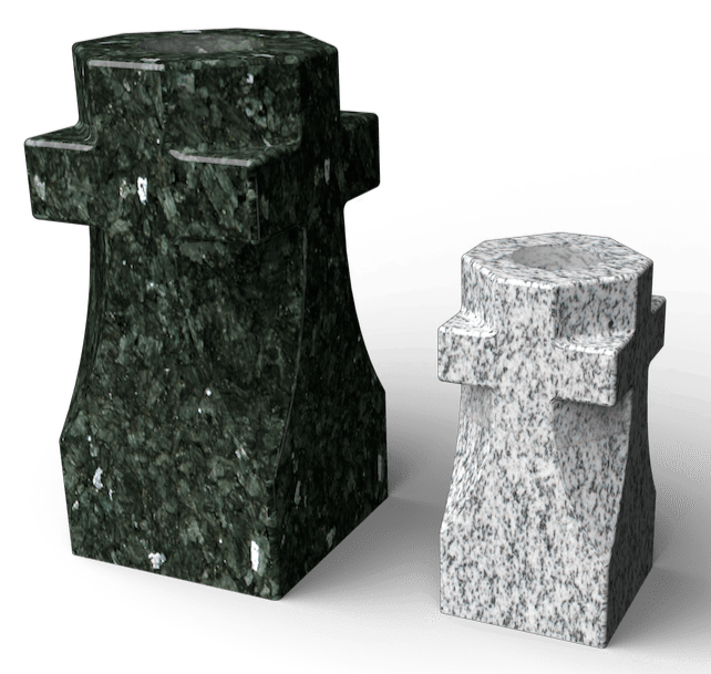 Two geometric stone sculptures, one dark green and the other light gray, with cross-like shapes on top.