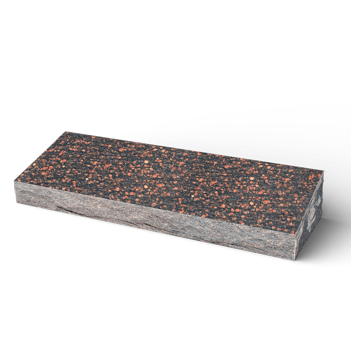 Rectangular block of cork material; dark brown and reddish speckles on top, grey sides.