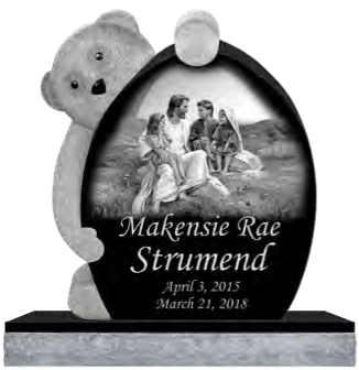 Gravestone with a teddy bear, picture of Jesus with children, and the name 