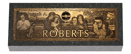 Bronze plaque on a gray stone. It has the family name 
