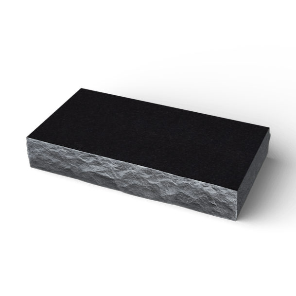 Black granite block with rough-hewn sides and a smooth, polished top surface.