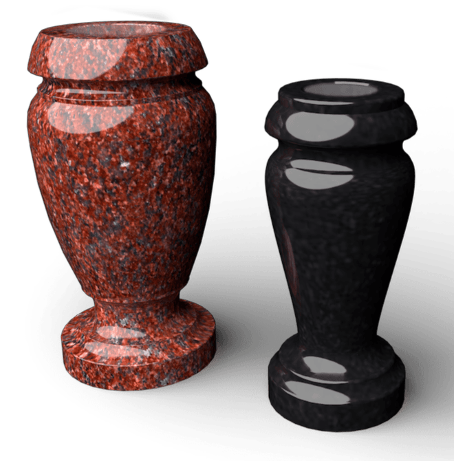 Two granite vases, one red, one black, with rounded tops and bases, on a white surface.