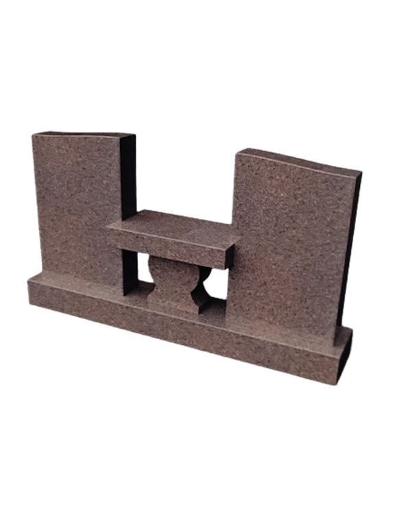 Brown granite memorial headstone with a central bench-like feature.