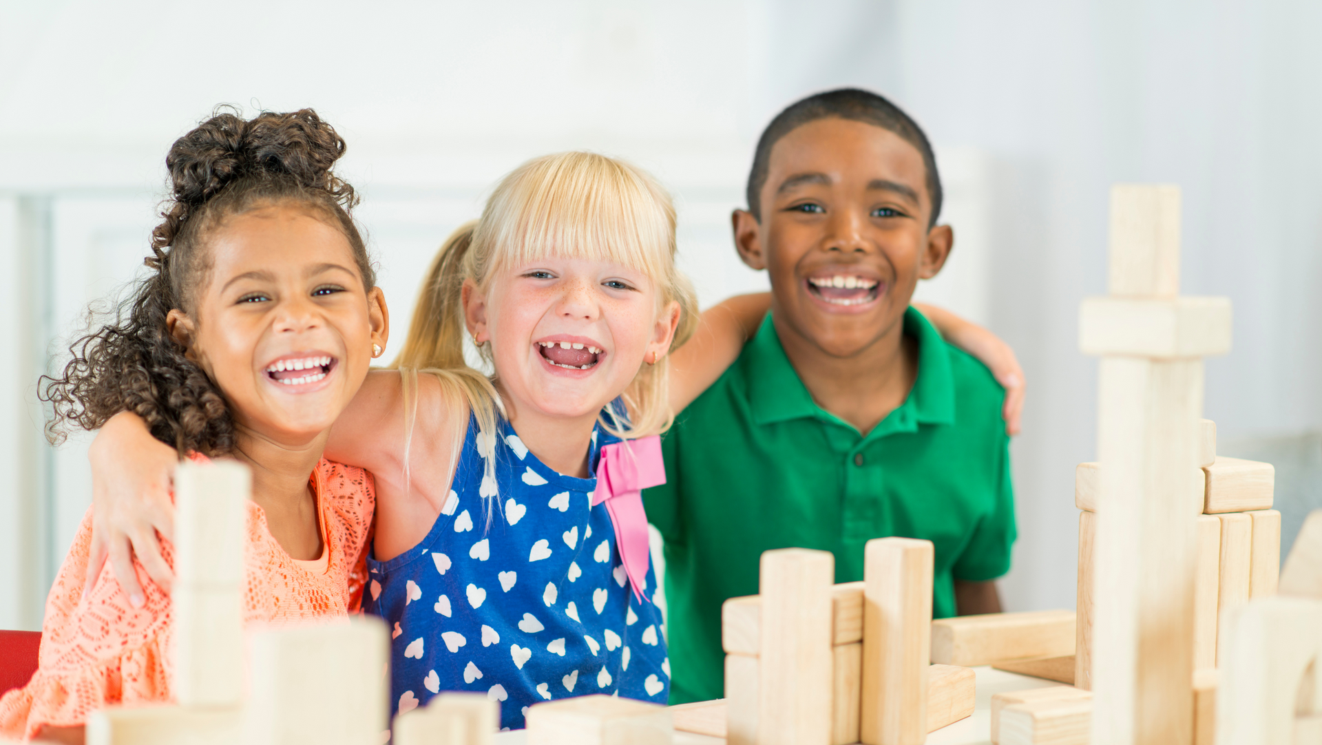 A group of children are playing with wooden blocks.