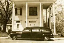 Black and white photo of hearse for Holman Howe Funeral Homes