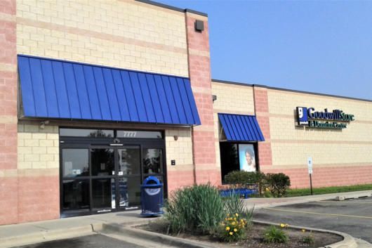 A building with a blue awning on the front of it