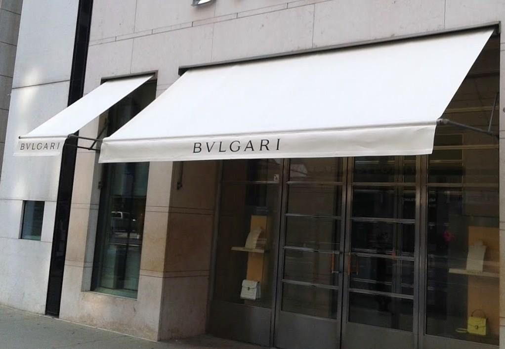 A store front with a white awning that says bvlgari