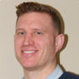 A close up of a man 's face with a smile on his face.