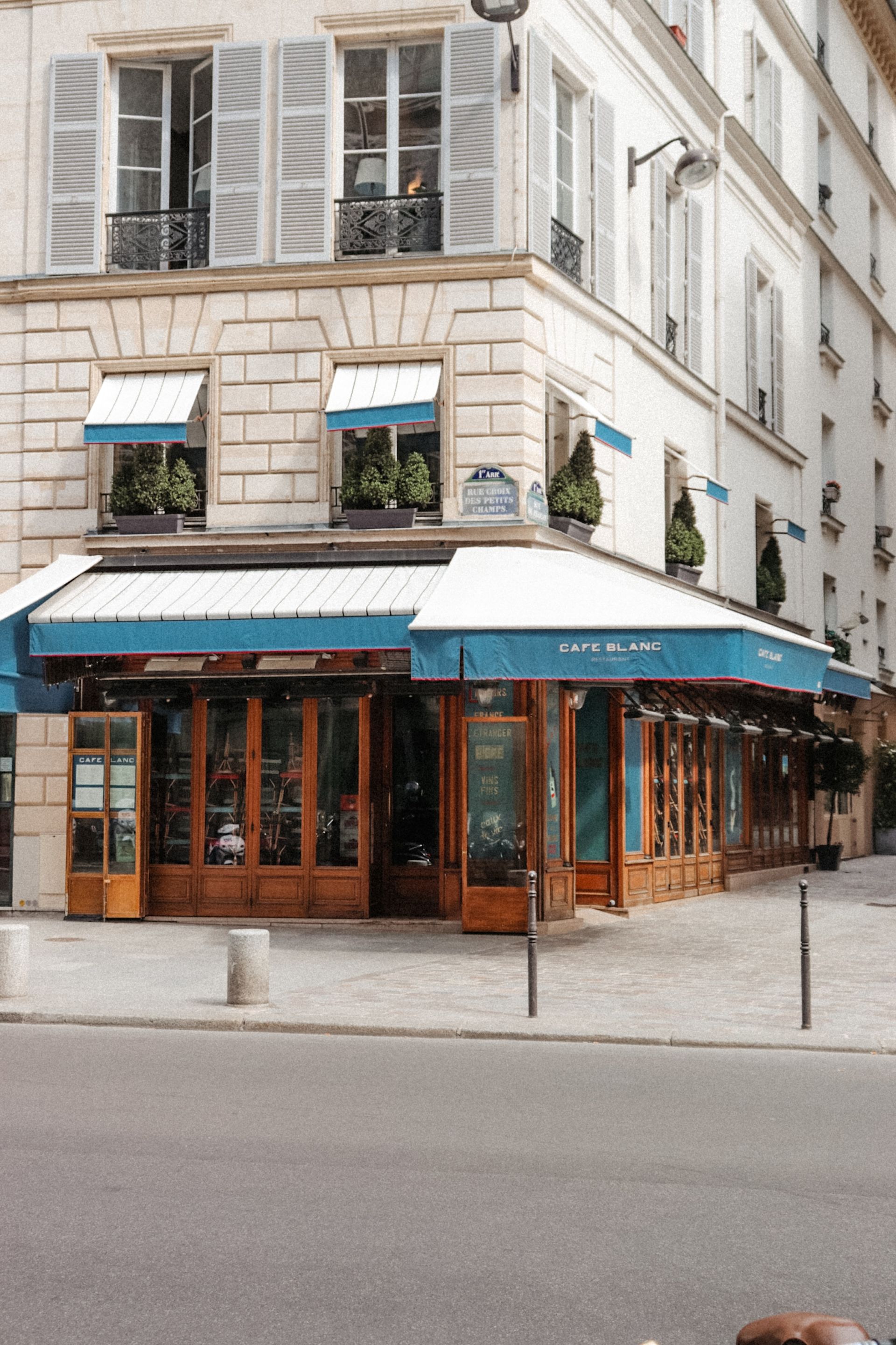 A building with a blue awning on the side of it