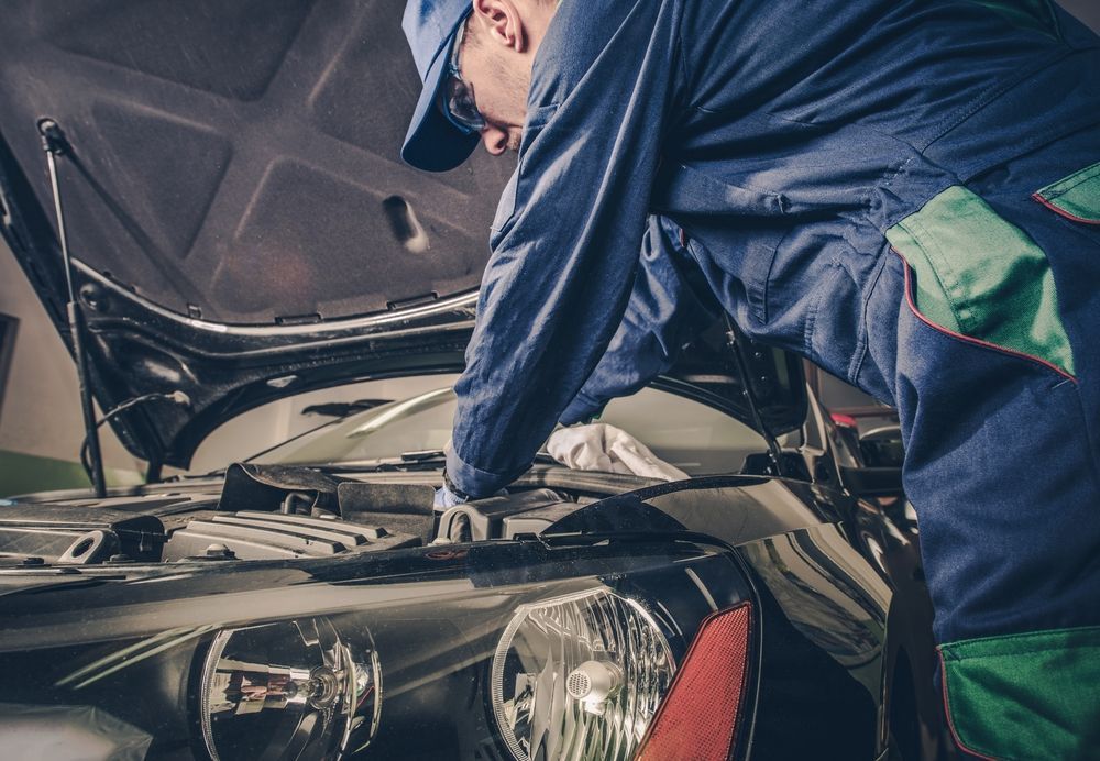 A mechanic servicing a vehicle.