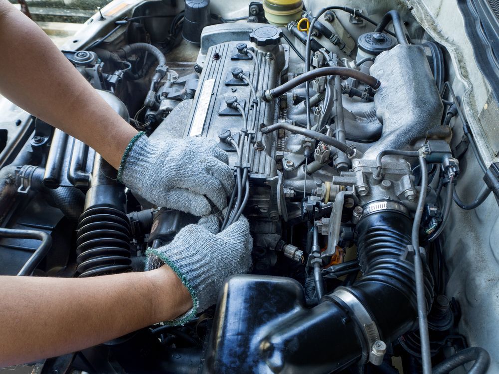 A Person is Working on the Engine of a Car — Bowral Auto Care In Mittagong, NSW