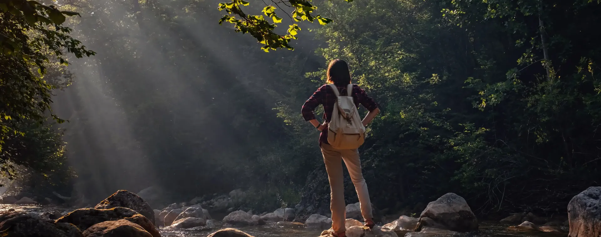 A woman with a backpack is going for a hike knowing her SEO website is working while she doesn't.