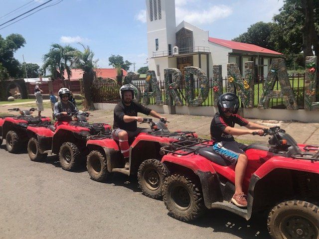 A row of atvs are parked in front of a sign that says carolina