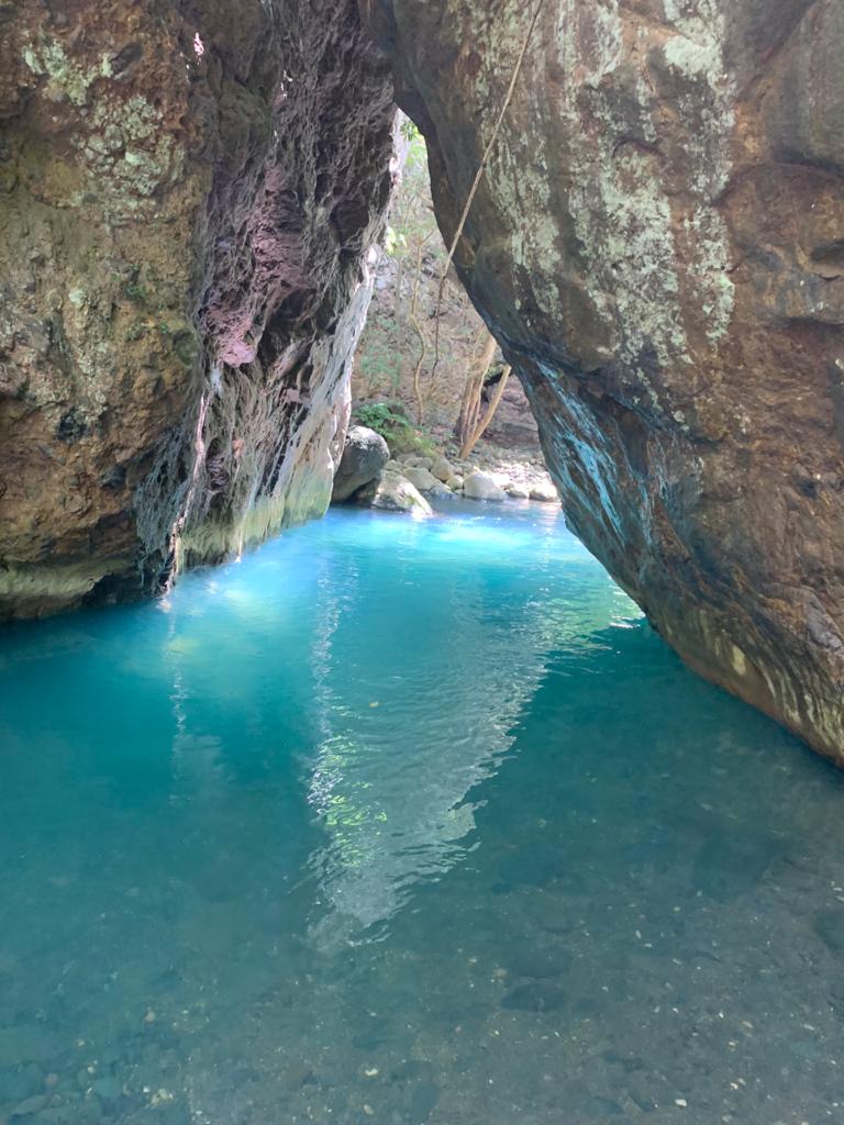 A small body of water surrounded by rocks in a cave.