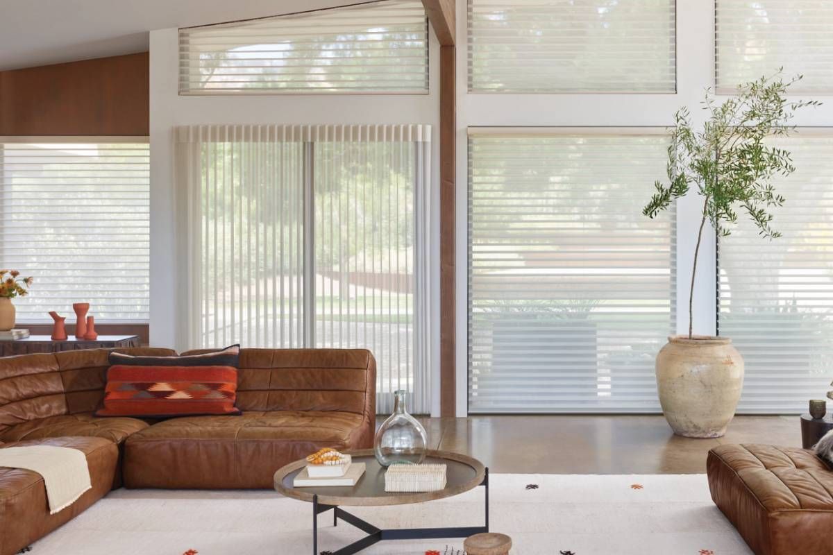 Hunter Douglas sliding panels on a sliding patio door and large windows in a living room