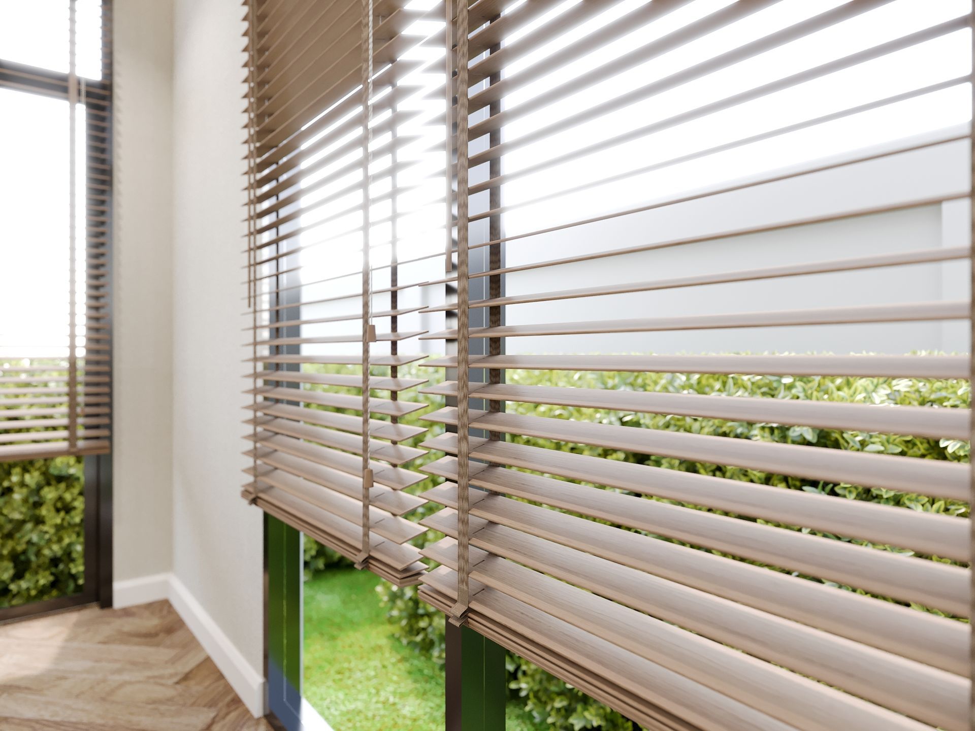 A room with blinds on the windows and a view of a garden.