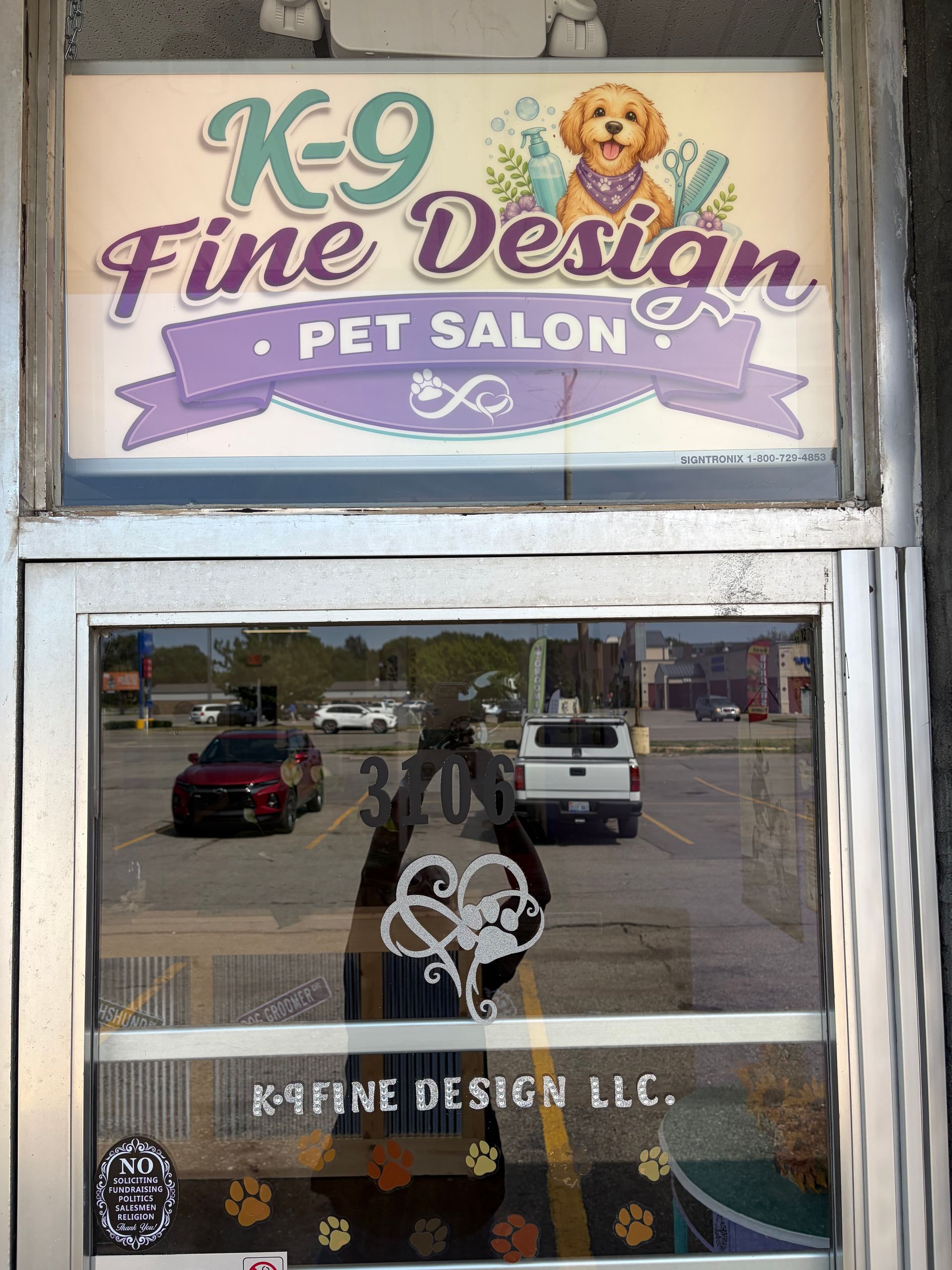 K9 Fine Design pet salon storefront with dog logo and glass doors