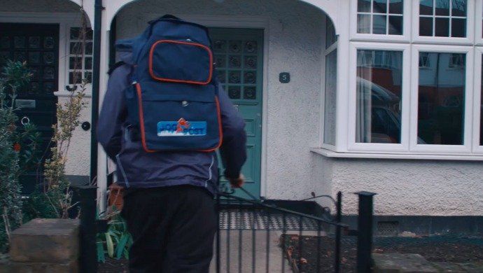 JogPost distributor with a delivery backpack outside a home