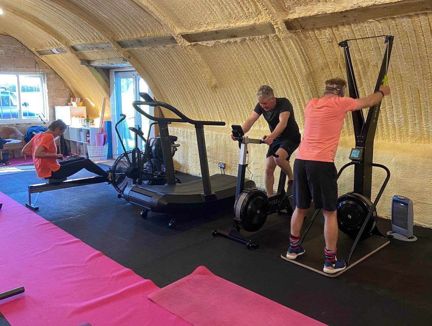 A group of people are using exercise equipment in a gym.