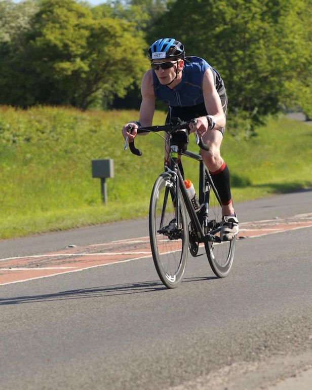 Matt Jolly wearing a helmet racing on a bike